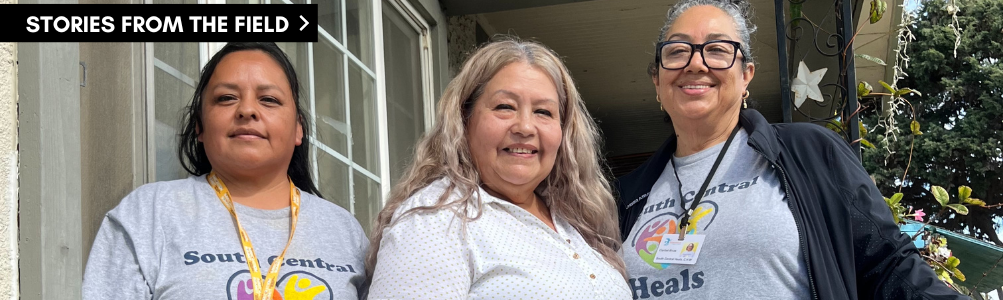 Photo of three people smiling.