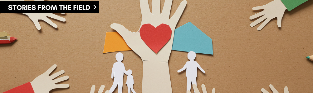 Stock photo of paper people and hands depicting community